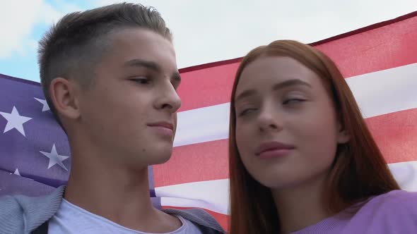 Couple of Teens Covered National USA Flag, Touching Foreheads, Enjoying Pastime