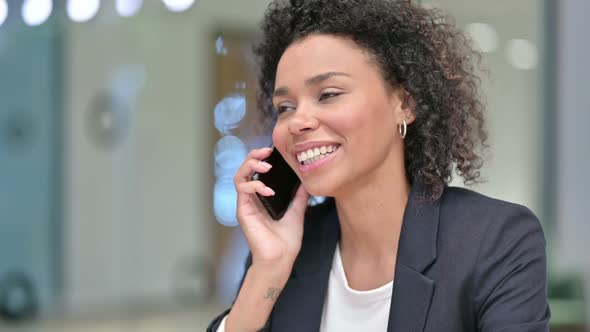 African Businesswoman Talking on Phone at Work