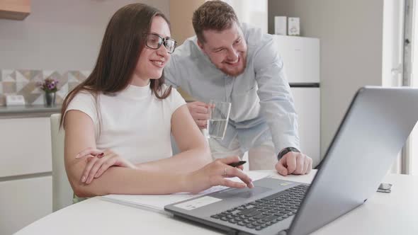 Adult Caucasian Couple at Home in Smart Working and Remote Work Job Activity Sitting at the Desk in