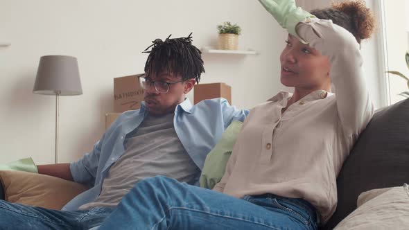 Young Couple Having Break during Cleaning