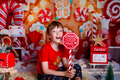 Kid reading a book at Christmas. Happy xmas and New Year, winter holiday concept  on red background. - PhotoDune Item for Sale