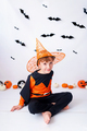 Happy Halloween background with orange pumpkin with and blonde boy in Halloween costume. - PhotoDune Item for Sale
