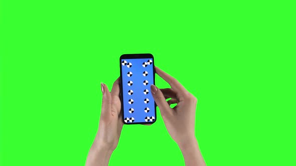 Woman Holds Smartphone By Two Hands and Sliding Pages Against Chroma Key Background