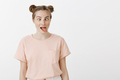 Playful bored girl with buns hairstyle and freckles in trendy pink t-shirt, sticking out tongue and - PhotoDune Item for Sale