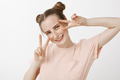 Waist-up shot of charming playful woman with cute buns and freckles, tilting head and smiling broadl - PhotoDune Item for Sale