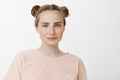 Relaxed good-looking female with two buns hairstyle and freckles, gazing with beautiful blue eyes at - PhotoDune Item for Sale