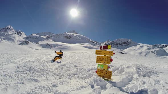 A young man snow kiting on a snowboard.