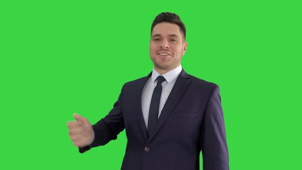 Business Man Pointing on Product and Talking To Camera on a Green Screen, Chroma Key.