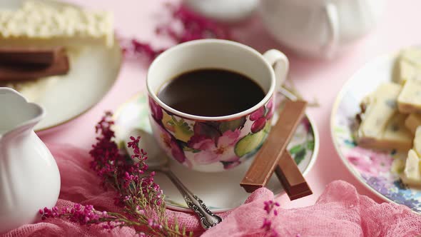 Delicious Dessert on Pink Background. Hot Coffee or Dark Chocolate with White Chocolate