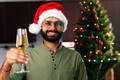 indian man drinking alcohol at home Christmas tree lights garland background - PhotoDune Item for Sale