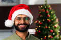 Happy young man wearing santa hat looking at camera celebrating New Year distance online party - PhotoDune Item for Sale