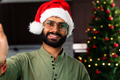 Happy young man wearing santa hat looking at camera celebrating New Year distance online party - PhotoDune Item for Sale