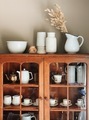 A Variety of White Pottery Grace an Old Sideboard in a Dining Room - PhotoDune Item for Sale