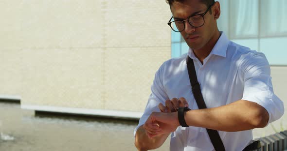 Man checking his smartwatch on street 