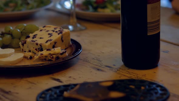 Close-up of wine bottle and meal on wooden table