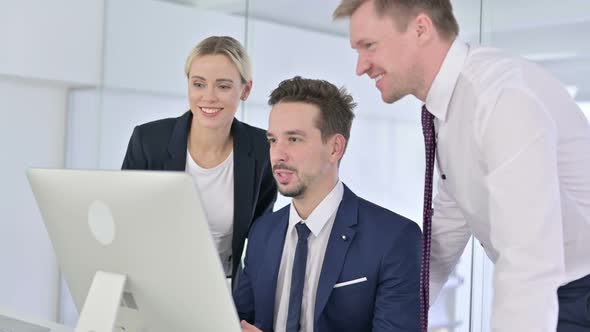 Attractive Business Team Doing Video Chat on Desktop in Office