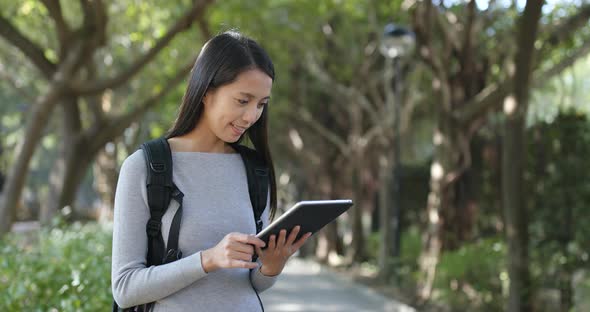 Woman use of tablet computer at outdoor park