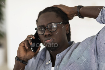 ile Talking On Cellphone, Worried Young African American Man Emotionally Reacting To Unpleasant Phone Call, Saying Pff, Closeup Portrait