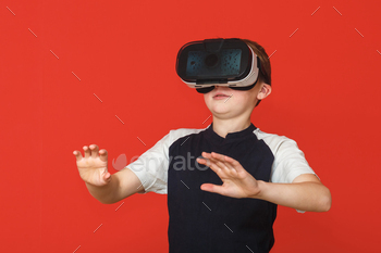  game on a red background. 3D gadget technology. Cardboard VR headset glasses