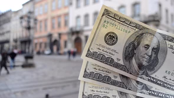 Three Hundred Dollar Bills on Blurred Background of European