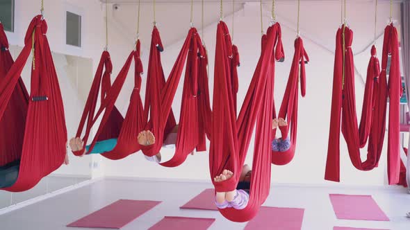 Sleepy Women Group with Bare Feet Relaxes in Hammocks