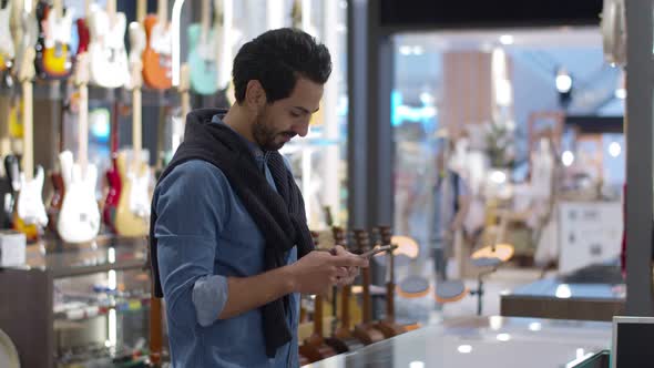 Young man paying with QR code by smartphone contactless