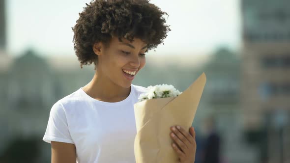 Cute Afro-American Girl Smiling and Rejoicing Beautiful Bouquet From Admirer