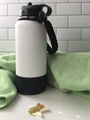 A Green Yoga Towel, A White Water Bottle, and a Small Pile of Vitamins on a White Counter - PhotoDune Item for Sale