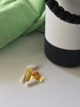 A Green Yoga Towel and a Small Pile of Vitamins on a White Counter - PhotoDune Item for Sale
