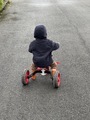 A Young Boy Rides a Tricycle on the Road on a Brisk Morning - PhotoDune Item for Sale