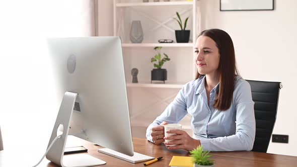 A Young Woman Is Using PC in the Office