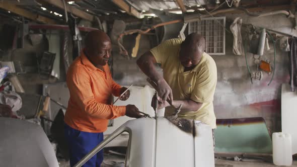 African men repairing a car