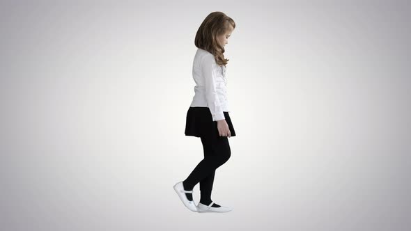 Little Girl with Long Hair Walking and Looking Down on Gradient Background.