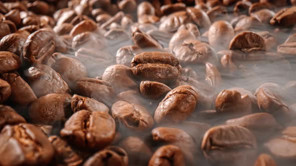 Close Up of Seeds of Coffee. Fragrant Coffee Beans Are Roasted Smoke Comes From Coffee Beans