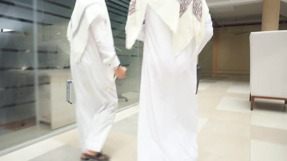 Back View on Arabian Sheikhs Going To Business Meeting