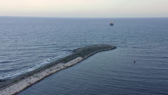 Breakwater pier at Haina port and ship in background, Dominican Republic. Aerial