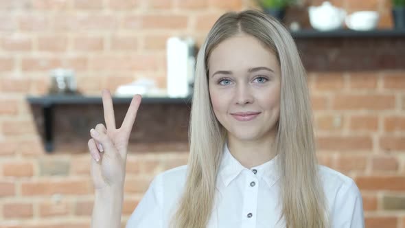 Woman Showing Victory Sign, Indoor