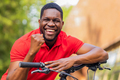 Portrait of handsome smiling stylish hipster with bike in park - PhotoDune Item for Sale