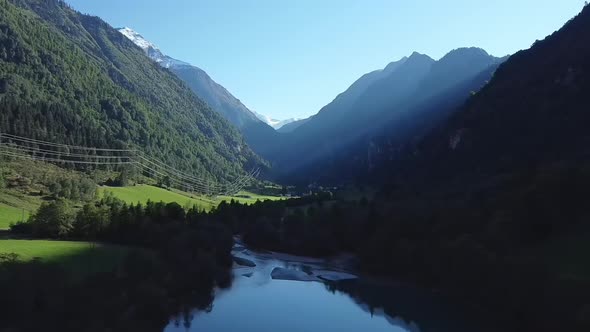 A lake in the shadow of the mountains, drone footage