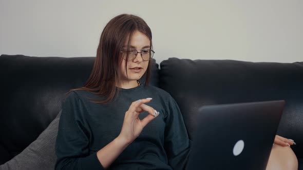 The Inspired Young Woman Red with Freckles and Glasses Teaches a Very Important Lesson Online to Her