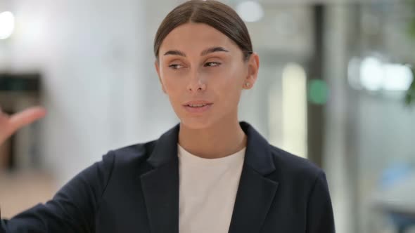 Portrait of Disappointed Businesswoman Doing Thumbs Down Sign