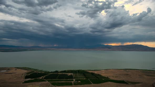 Time lapse of dark storm clouds building over lake