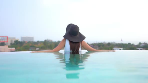 Young asian woman enjoy around outdoor swimming pool for leisure