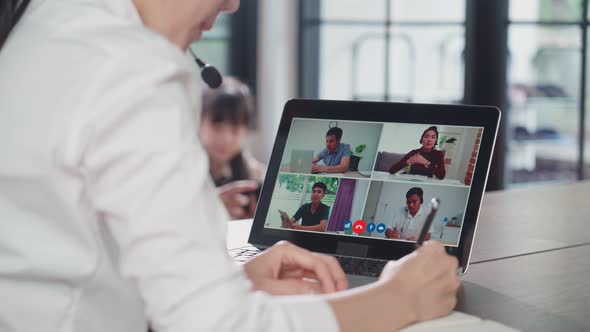 Asian business woman work and talking to colleague team about plan in video conference in house.