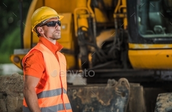 30s Wearing Safety Accessories. Building Machinery in a Background. Industrial Zone.