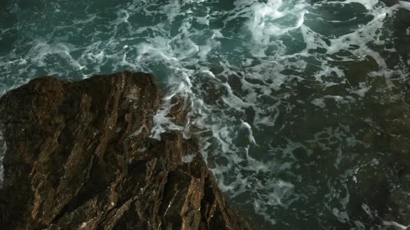 Stormy waves that beat against big rocks