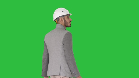 Engineer in helmet with briefcase walking on a Green Screen