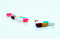 Multi-color pills on white background. Antibiotic capsule pills. Prescription drugs. Pharmaceutical - PhotoDune Item for Sale