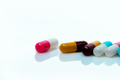 Multi-color antibiotic capsule pills on white background. Antibiotic drug resistance. Prescription - PhotoDune Item for Sale