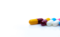 Antibiotic capsule pills on white background. Antibiotic drug resistance. Red-yellow, Blue-white - PhotoDune Item for Sale